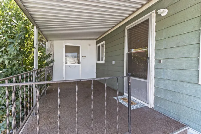 a view of a hallway with wooden floor and closet