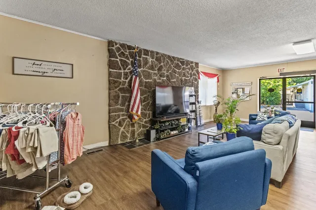 a living room with furniture and wooden floor