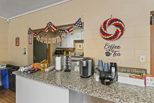 a room with a dining table a table and chairs