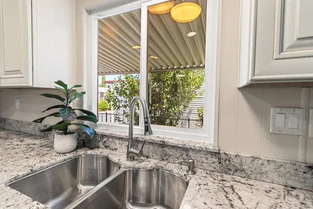 a kitchen that has a table chairs in it and wooden floors