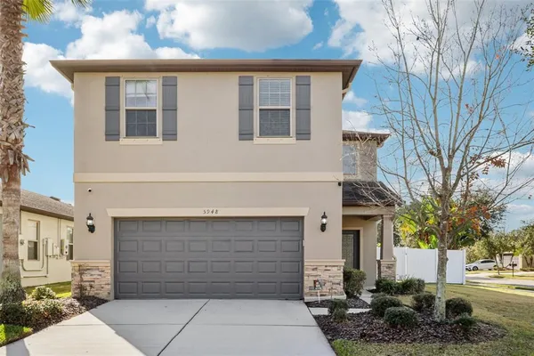 a front view of a house with a garage