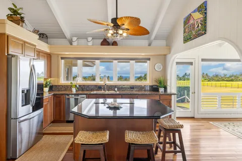 a large kitchen with a table and chairs