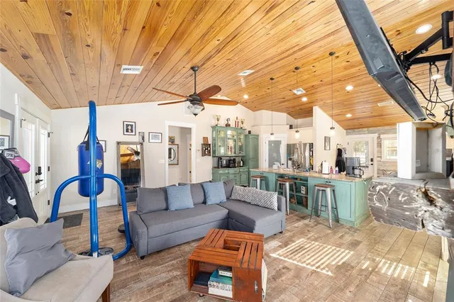 a kitchen with a table chairs refrigerator and cabinets