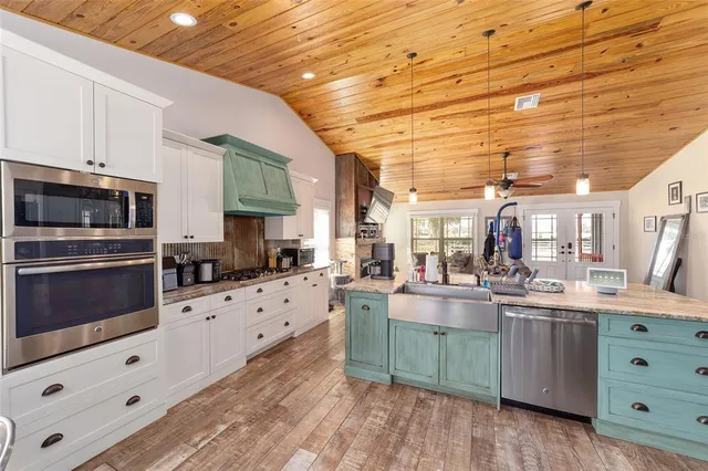 a kitchen with lots of counter top space and painting on the wall