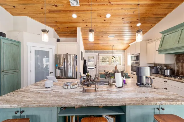 a kitchen with sink cabinets and living room view