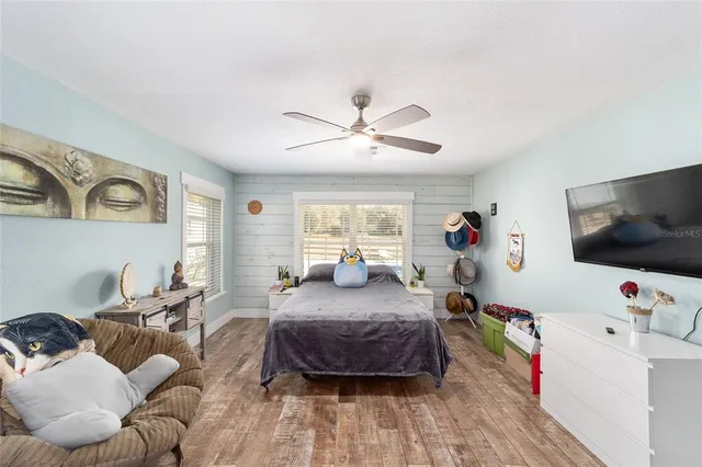 a bedroom with a bed a couch and a window