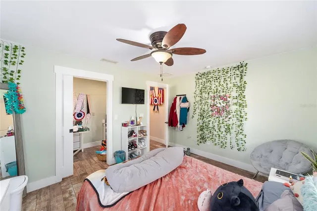 a living room with a large window and chairs