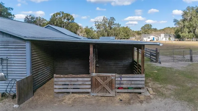 a view of a street with wooden fence