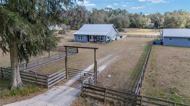 an aerial view of a house with a yard