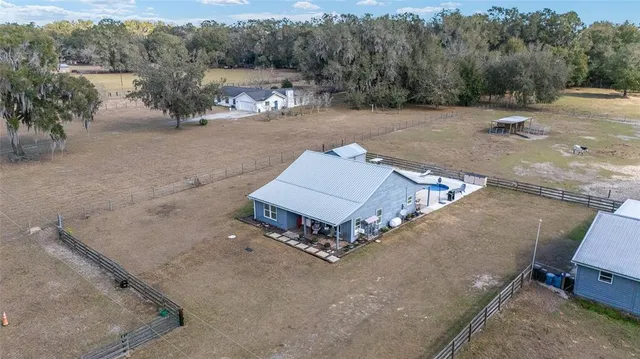 a view of a house with a yard and wooden fence