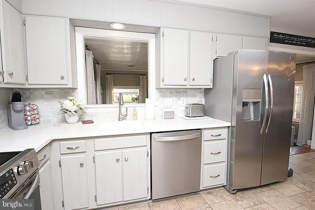 a kitchen with cabinets and stainless steel appliances