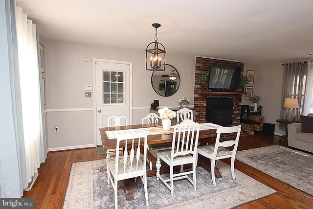 a dining room with furniture window and wooden floor