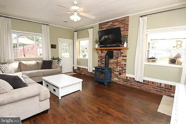a living room with fireplace furniture and a flat screen tv