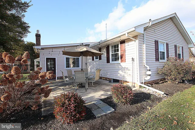 a backyard of a house with yard and outdoor seating