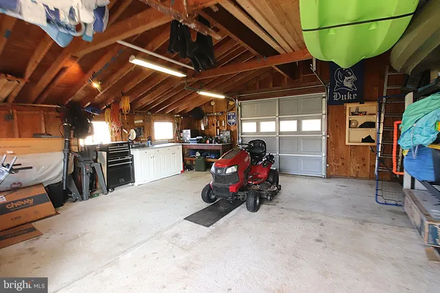 a view of a garage with a car and parked car