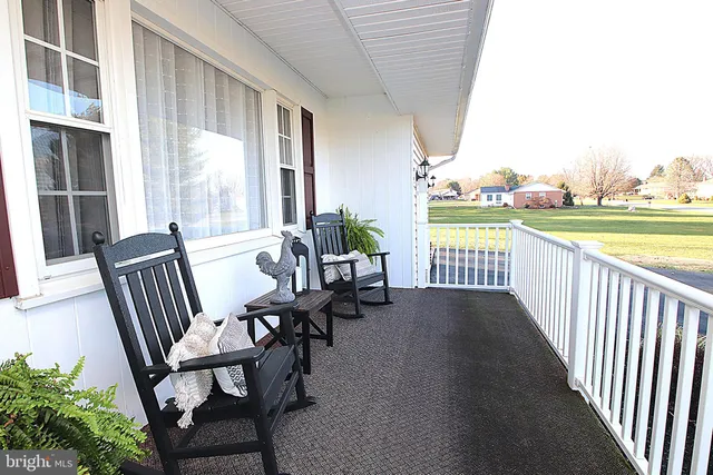a view of a chair and tables in the balcony
