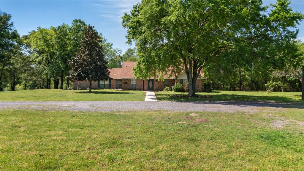 View of front of home with brick siding and a front yard