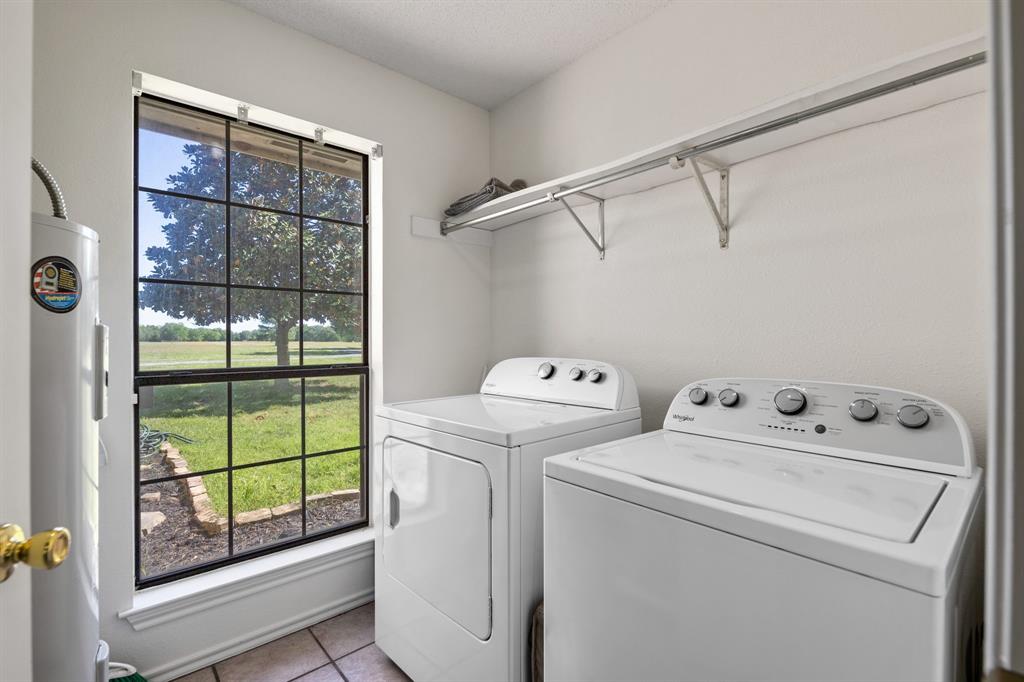 321 Vz County Road 2602 Wills Point, TX 75169 - Photo 30 of 39 Washroom featuring laundry area, electric water heater, light tile patterned flooring, and independent washer and dryer