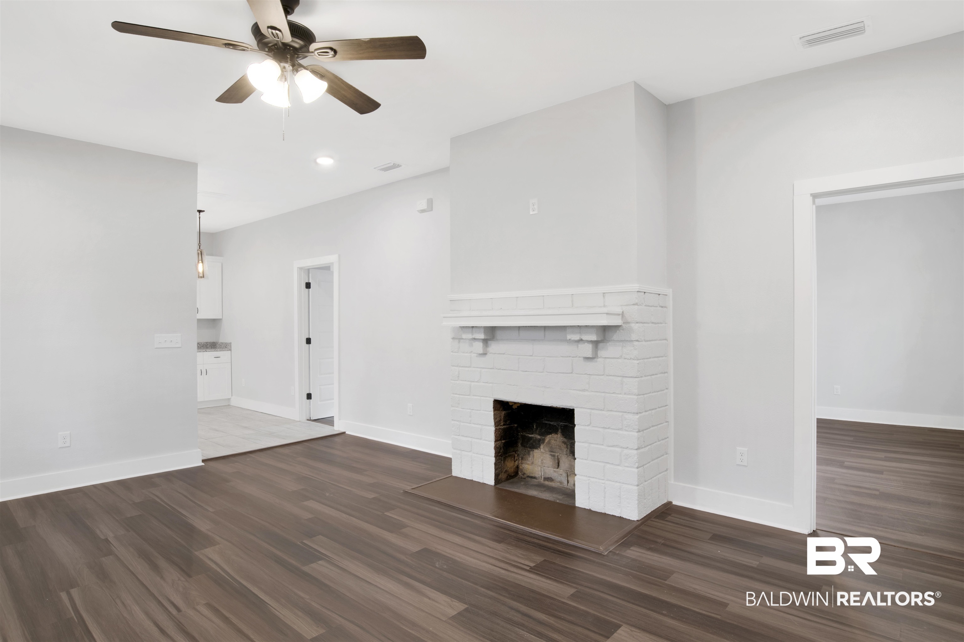 302 1st Street Mobile, AL 36611 - Photo 6 of 28 Unfurnished living room with a fireplace, dark wood-type flooring, and ceiling fan