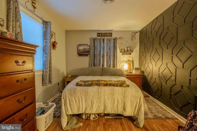 a bedroom with a bed and a mirror