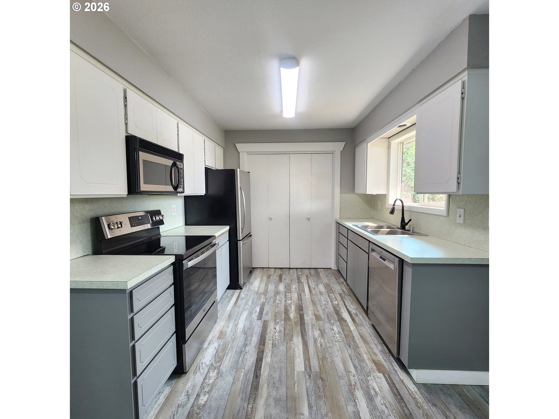 54047 West Lane Road Scappoose, OR 97056 - Photo 6 of 44 a kitchen with a sink stove top oven and refrigerator