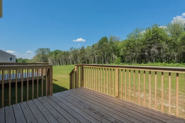 a view of balcony with wooden floor and fence