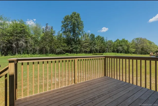 a balcony with wooden floor and fence