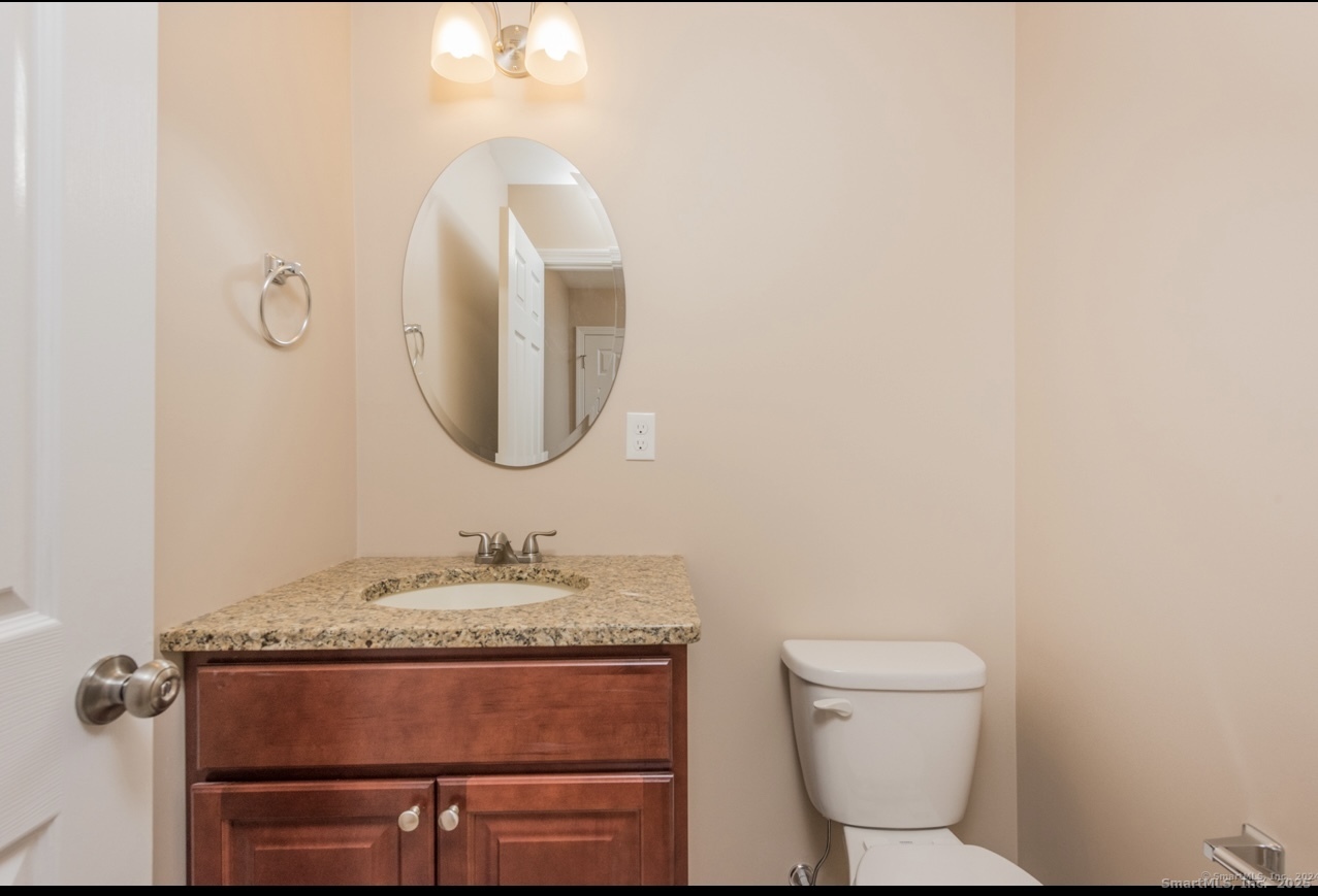13 Nature Avenue, Unit A Colchester, CT 06415 - Photo 15 of 34 a bathroom with a granite countertop toilet sink and mirror