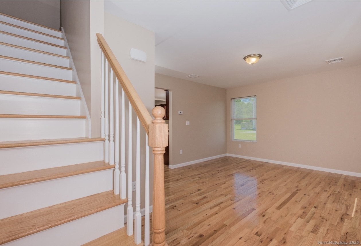 13 Nature Avenue, Unit A Colchester, CT 06415 - Photo 18 of 34 a view of entryway with wooden floor and stairs