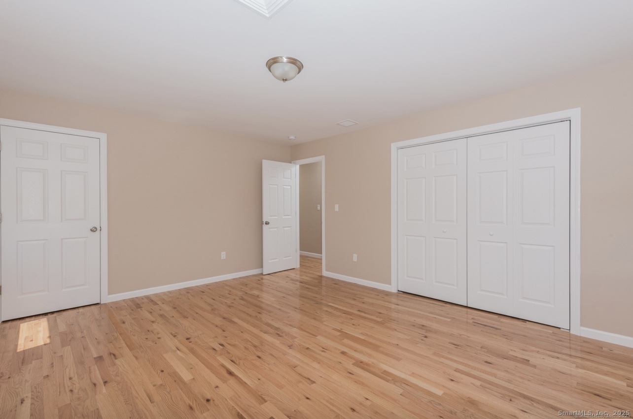 13 Nature Avenue, Unit A Colchester, CT 06415 - Photo 19 of 34 a view of an empty room with wooden floor