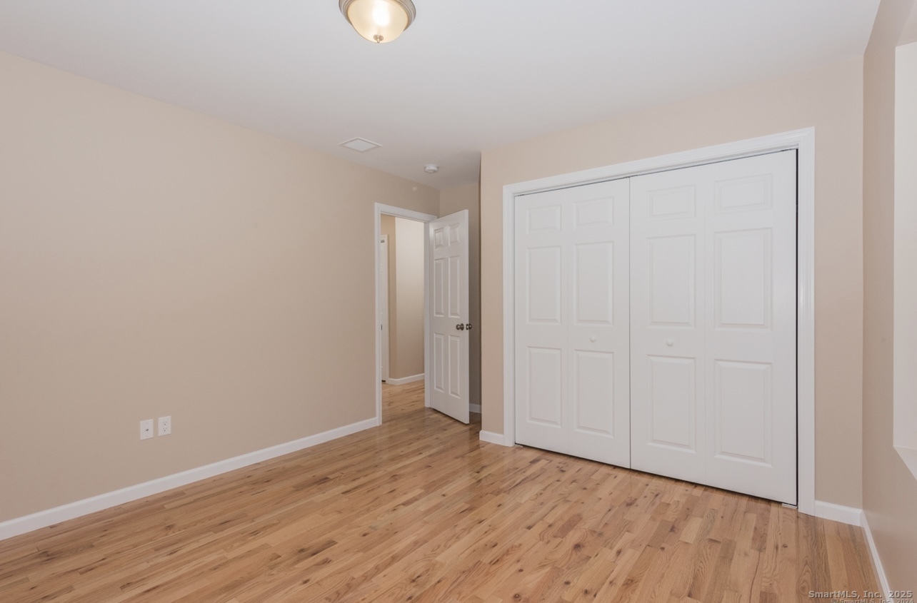 13 Nature Avenue, Unit A Colchester, CT 06415 - Photo 30 of 34 a view of an empty room with wooden floor