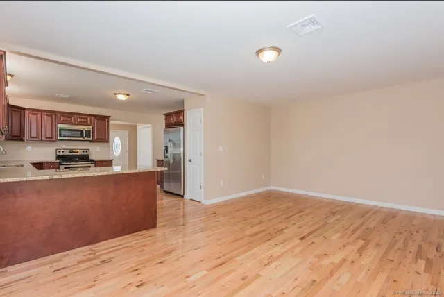 a view of kitchen and wooden floor