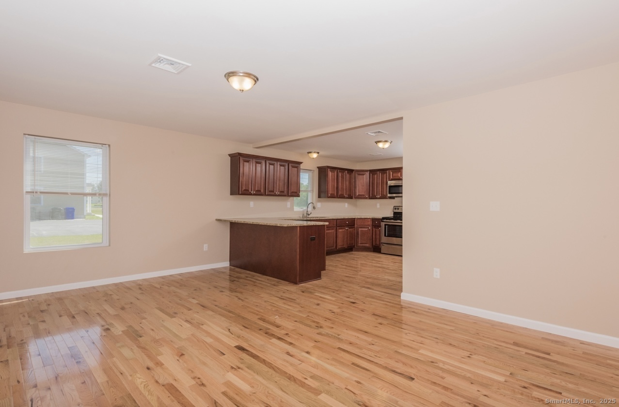 13 Nature Avenue, Unit A Colchester, CT 06415 - Photo 9 of 34 a view of kitchen and wooden floor