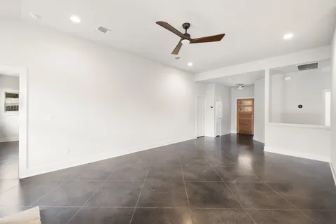 an empty room with closet and windows