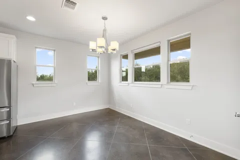 a view of a room with a large windows and a chandelier