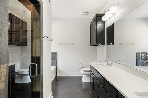 a bathroom with a sink a toilet and mirror