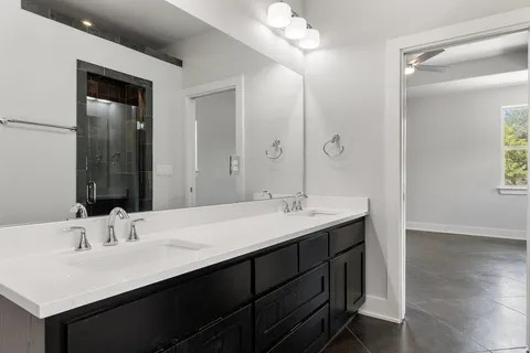 a bathroom with 2 sink and a mirror