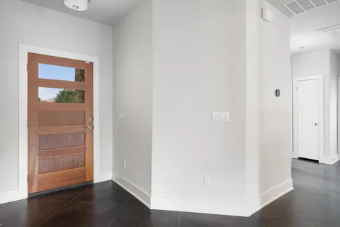 a view of a hallway with wooden floor