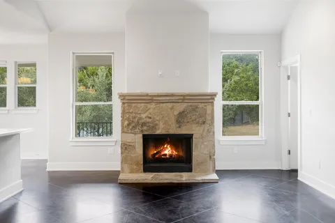 a living room with a fireplace and a window