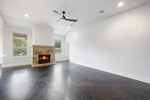 a view of a livingroom with a fireplace and window