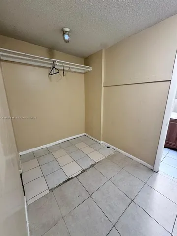 a view of kitchen with stainless steel appliances cabinets and wooden floor