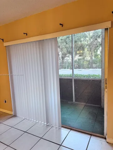 an empty room with wooden floor and window