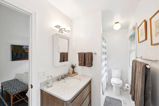 a bathroom with a sink toilet and shower