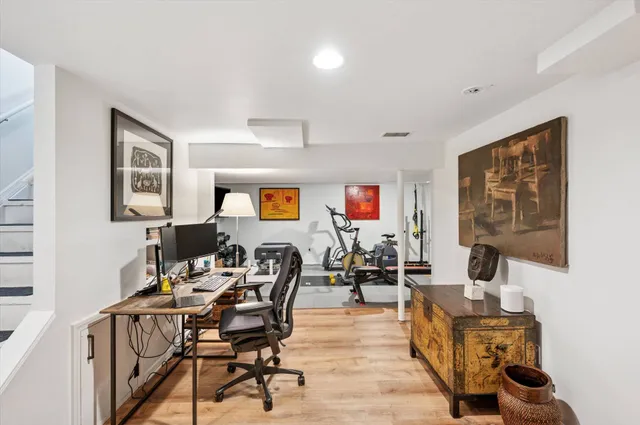 a work room with furniture and wooden floor