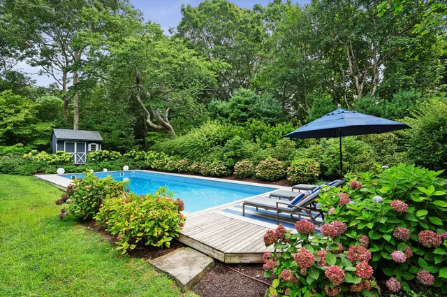 a view of a chair and table in the garden