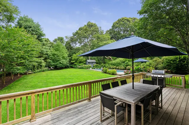 a view of house with furniture and backyard