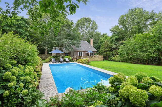 a view of a swimming pool and lounge chairs