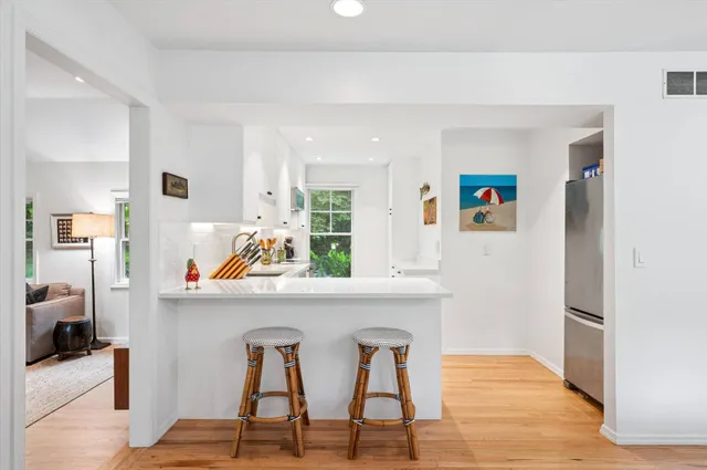 a view of kitchen with furniture and wooden floor