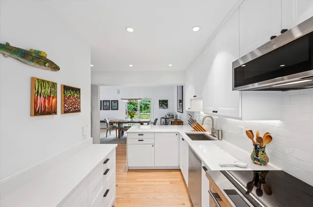 a kitchen with a sink appliances and cabinets