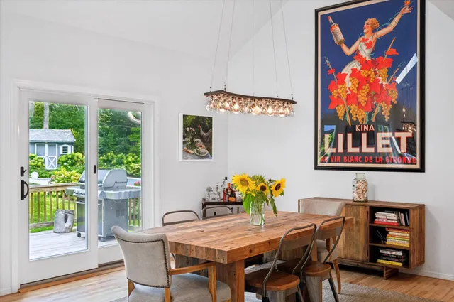 a dining room with furniture and wooden floor
